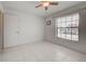 Bright bedroom featuring a ceiling fan, tile floors, and a view from a window at 766 Avenida Estancia # 196, Venice, FL 34292