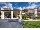 Exterior view of the carport with parking spaces, sidewalk, and nicely landscaped flower garden at 766 Avenida Estancia # 196, Venice, FL 34292