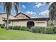 Community clubhouse with lush landscaping, tile roof, and clearly marked signage at 766 Avenida Estancia # 196, Venice, FL 34292