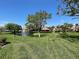 Scenic community view with a pond, fountain, and gazebo on a lush green lawn under a clear blue sky at 766 Avenida Estancia # 196, Venice, FL 34292