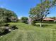 Beautiful community view featuring a pond with fountain, lush lawns, and a screened-in gazebo at 766 Avenida Estancia # 196, Venice, FL 34292