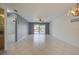 Bright living area with tile floors, a ceiling fan, balcony access, and a convenient bar area for entertaining at 766 Avenida Estancia # 196, Venice, FL 34292
