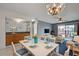 Inviting living room area featuring an elegant dining table set and a cozy seating area with balcony access at 766 Avenida Estancia # 196, Venice, FL 34292