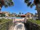 Beautiful community pool with palm trees, surrounded by lounge chairs and umbrellas at 766 Avenida Estancia # 196, Venice, FL 34292