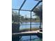 Relaxing pool area with screened enclosure offering scenic lake views at 105 Treviso Ct, North Venice, FL 34275