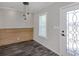 Empty dining area with wood accent wall, pendant lighting, and dark flooring at 127 Nautical Dr, North Port, FL 34287