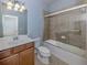 Clean and functional bathroom with tub/shower combo and wood vanity at 13240 Amerigo Ln, Venice, FL 34293