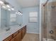 Double vanity bathroom with shower and tile floors at 13240 Amerigo Ln, Venice, FL 34293