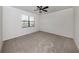 Spacious bedroom with ceiling fan and neutral carpeting at 13240 Amerigo Ln, Venice, FL 34293