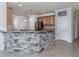 Kitchen with granite countertops and stone accent wall at 13240 Amerigo Ln, Venice, FL 34293