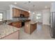 Modern kitchen with granite countertops, stainless steel appliances, and island at 13240 Amerigo Ln, Venice, FL 34293