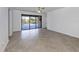 Spacious living room with tile flooring and sliding glass doors leading to the pool area at 13240 Amerigo Ln, Venice, FL 34293