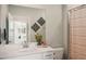 Bathroom with neutral walls, white vanity, decorative accents, and a shower/tub combo at 19045 Moscato Ct, Venice, FL 34293