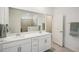 Bright bathroom features double sinks, a large mirror, and tiled shower at 19045 Moscato Ct, Venice, FL 34293