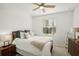 Bedroom with ceiling fan, side tables, and a large window at 19045 Moscato Ct, Venice, FL 34293