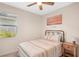 Comfortable bedroom with ceiling fan, window, and colorful bedding at 19045 Moscato Ct, Venice, FL 34293