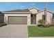 Traditional home boasting a two-car garage, paved driveway, and manicured front lawn at 19045 Moscato Ct, Venice, FL 34293