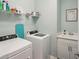 Well-equipped laundry room with washer, dryer, sink, and storage at 19045 Moscato Ct, Venice, FL 34293