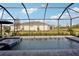 Relaxing screened pool area with waterfall feature and landscaped surroundings for enjoying the outdoors at 19045 Moscato Ct, Venice, FL 34293