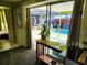 View of the pool from inside the house through sliding glass doors at 231 Victoria Rd, Venice, FL 34293