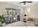 Bright Gathering room with sliding glass doors leading to a screened lanai at 25544 Royal Tern Ln, Englewood, FL 34223