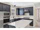 Modern kitchen with stainless steel appliances and dark cabinetry at 25544 Royal Tern Ln, Englewood, FL 34223