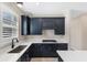 Modern kitchen with stainless steel appliances and dark cabinetry at 25544 Royal Tern Ln, Englewood, FL 34223