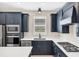 Modern kitchen with stainless steel appliances and dark cabinetry at 25544 Royal Tern Ln, Englewood, FL 34223