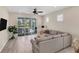 Living room with sliding glass doors leading to a screened lanai at 25544 Royal Tern Ln, Englewood, FL 34223