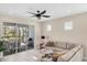 Living room with sliding glass doors and access to a lanai at 25544 Royal Tern Ln, Englewood, FL 34223