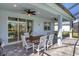 Covered patio with outdoor dining furniture and grill at 25544 Royal Tern Ln, Englewood, FL 34223