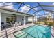 Relaxing screened pool and patio with outdoor dining at 25544 Royal Tern Ln, Englewood, FL 34223