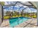 Private screened pool with a water feature in backyard at 25544 Royal Tern Ln, Englewood, FL 34223