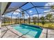 Private screened pool and lanai with water feature at 25544 Royal Tern Ln, Englewood, FL 34223