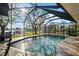 Relaxing pool with screened enclosure, patio furniture, and tranquil water views at 1701 Boca Raton Ct, Punta Gorda, FL 33950