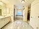 Elegant bathroom with soaking tub, double vanity, and ample storage at 18194 Driggers Ave, Port Charlotte, FL 33948