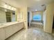 Main bathroom with double vanity and garden tub at 18194 Driggers Ave, Port Charlotte, FL 33948