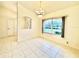 Bright dining room with tile floors and view to backyard at 18194 Driggers Ave, Port Charlotte, FL 33948
