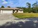 One-story house with attached garage and spacious lawn at 18194 Driggers Ave, Port Charlotte, FL 33948