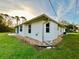 Exterior view of house showcasing landscaping and yard at 18194 Driggers Ave, Port Charlotte, FL 33948