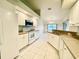 Bright eat-in kitchen with white cabinets and granite counters at 18194 Driggers Ave, Port Charlotte, FL 33948