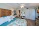 Bedroom with king-size bed, ornate headboard, and access to bathroom at 250 Santa Maria St # 118, Venice, FL 34285