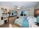 Bedroom includes a king-size bed, decorative wall accents, and a dresser at 250 Santa Maria St # 118, Venice, FL 34285