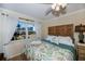Bedroom with king-size bed, wood headboard, and ocean view at 250 Santa Maria St # 118, Venice, FL 34285