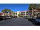 Condo building with parking and tropical landscaping at 250 Santa Maria St # 118, Venice, FL 34285