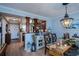 Dining room with glass table, chandelier, and hardwood floors at 250 Santa Maria St # 118, Venice, FL 34285