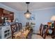 Dining room with glass table, chandelier, and hardwood floors at 250 Santa Maria St # 118, Venice, FL 34285