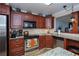 Kitchen with wood cabinets, granite counters, and stainless appliances at 250 Santa Maria St # 118, Venice, FL 34285