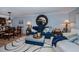 Living room with blue sofa and patterned rug at 250 Santa Maria St # 118, Venice, FL 34285