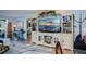 Living room with large TV and built-in shelving at 250 Santa Maria St # 118, Venice, FL 34285
